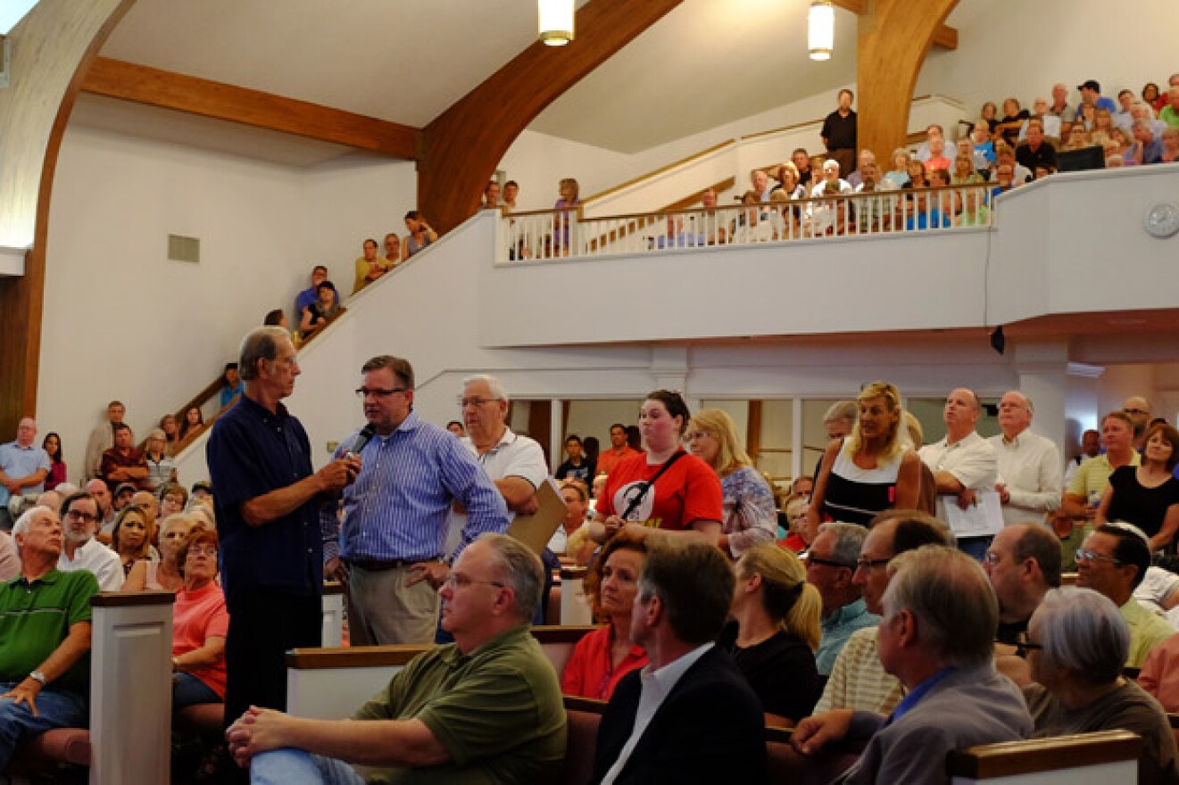 Shaken residents line up inside Edmond's Waterloo Baptist Church to voice concerns and ask representatives from the Corporation Commission and the state Geological Survey questions about recent earthquakes.